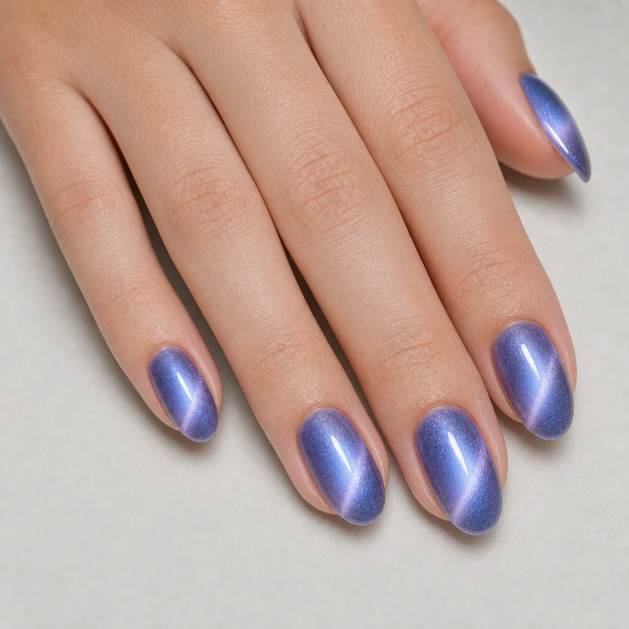 Blue aura cat eye nails with a soft center glow